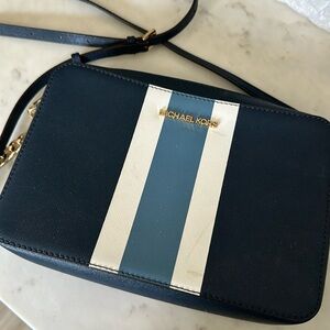 Michael Kors purse with adjustable strap and gold chain.